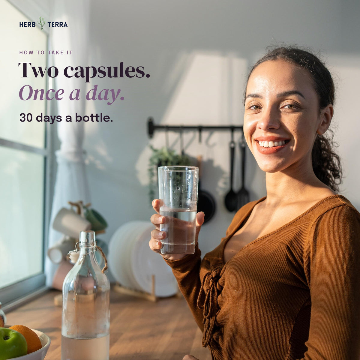 Herb Terra Un-Bloat Enzymes and Probiotics 60 Veg Capsules: how to take, two capsules once a day, woman with a glass of water